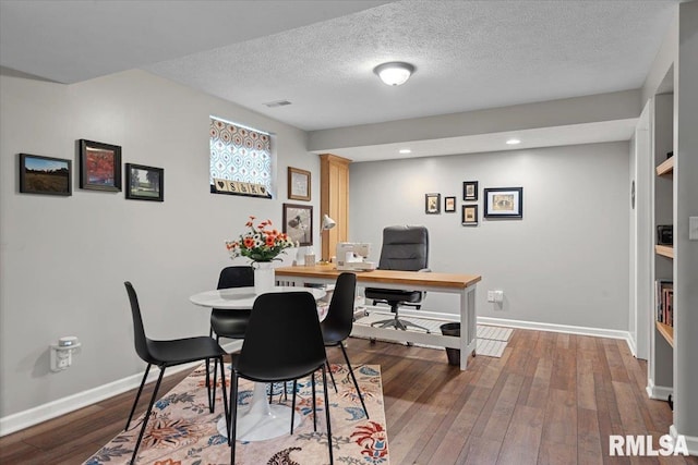 home office with visible vents, baseboards, recessed lighting, hardwood / wood-style flooring, and a textured ceiling