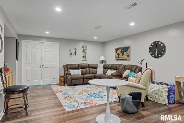 living room with recessed lighting, visible vents, and light wood-style floors