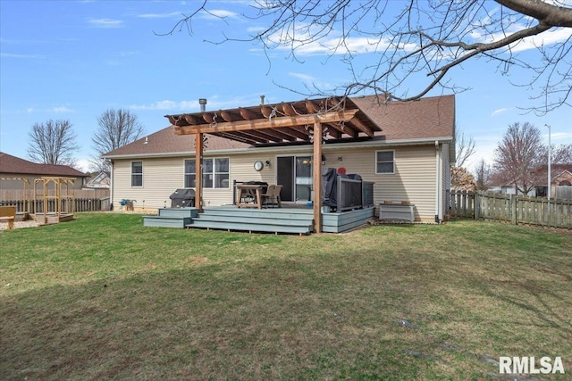 rear view of property with a deck, a lawn, a pergola, and a fenced backyard