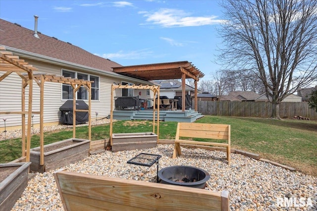 exterior space featuring fence, an outdoor fire pit, a deck, a pergola, and a vegetable garden