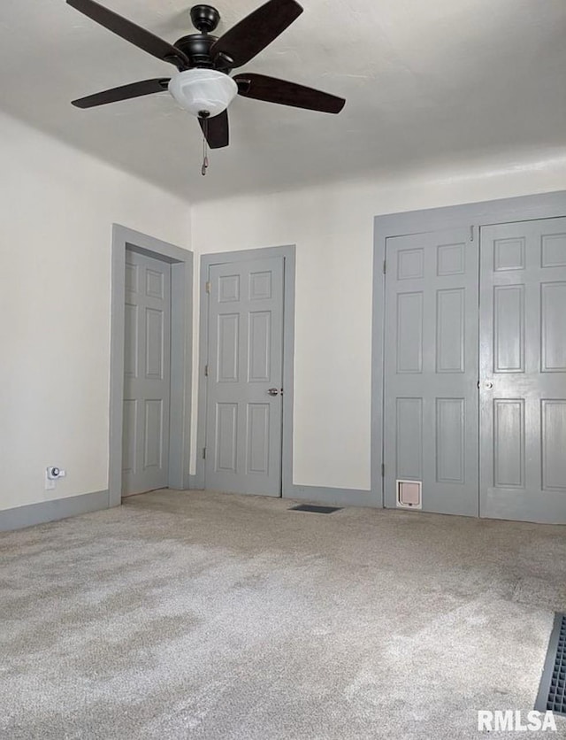 unfurnished bedroom with carpet, baseboards, and ceiling fan