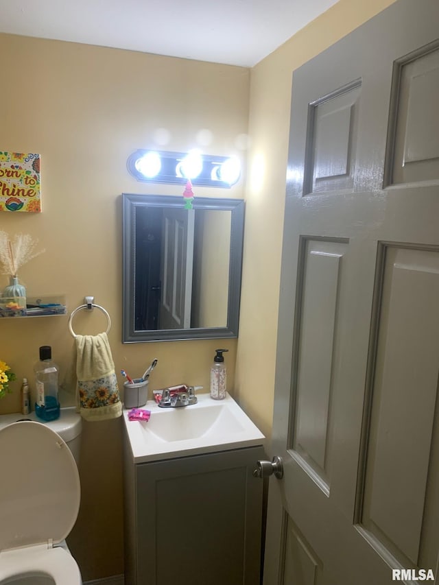 half bathroom featuring toilet and vanity