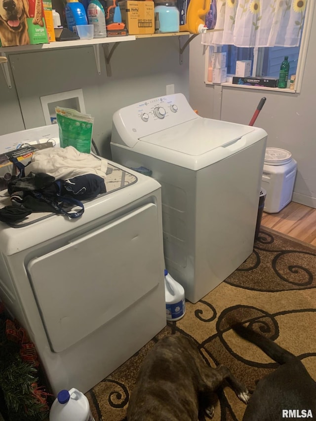 laundry room featuring separate washer and dryer, light wood-style flooring, and laundry area