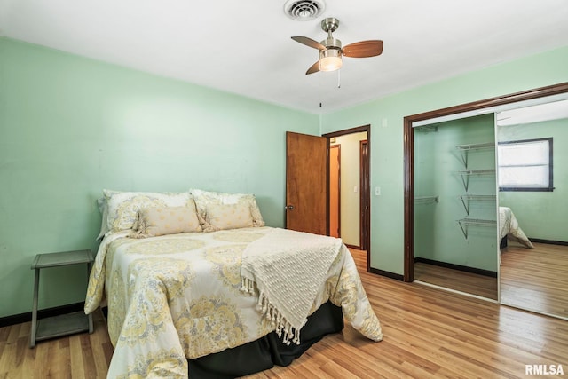 bedroom with visible vents, a closet, light wood-style floors, baseboards, and ceiling fan