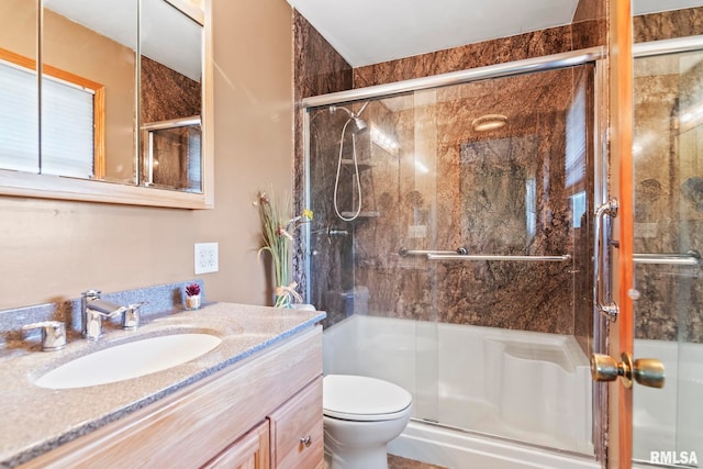 full bathroom with a shower stall, toilet, and vanity