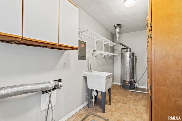 laundry area with cabinet space, gas water heater, baseboards, and electric panel