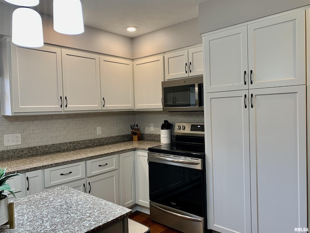 kitchen featuring backsplash, appliances with stainless steel finishes, and white cabinets