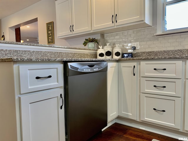 kitchen with dark wood-type flooring, backsplash, white cabinets, stone counters, and dishwasher