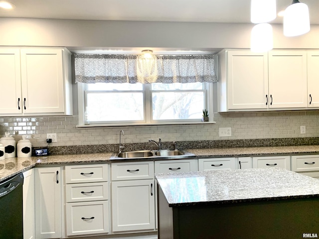 kitchen with a wealth of natural light, a sink, white cabinets, decorative backsplash, and dishwasher