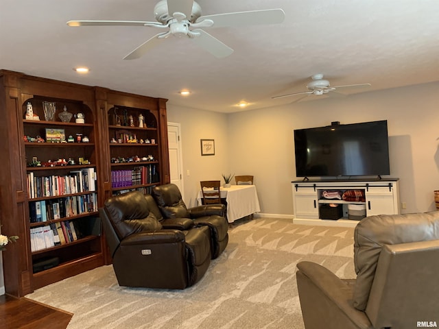 living room with light carpet, recessed lighting, baseboards, and a ceiling fan