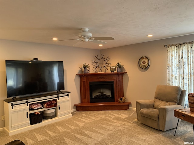 carpeted living room with recessed lighting, baseboards, and a fireplace with raised hearth