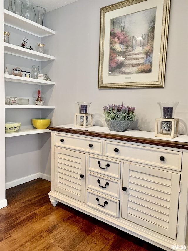 bar featuring dark wood finished floors and baseboards