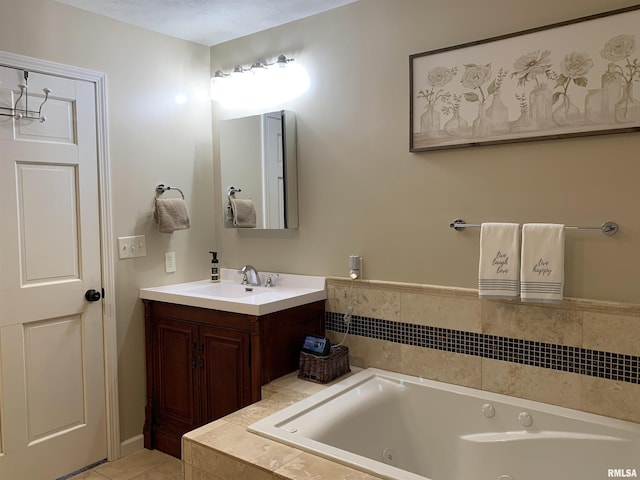 bathroom with vanity, a tub with jets, and tile patterned flooring