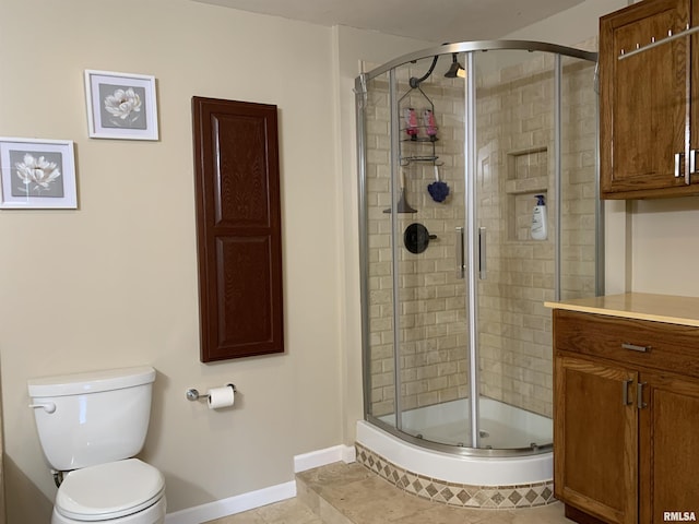 full bath featuring tile patterned flooring, a shower stall, toilet, and baseboards