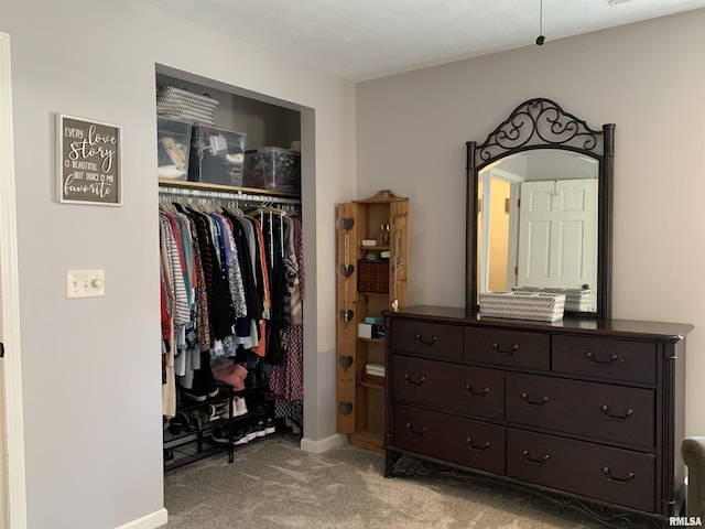 bedroom featuring a closet, baseboards, and carpet