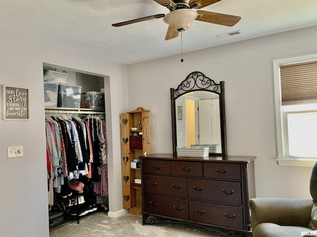 bedroom featuring light colored carpet, visible vents, a closet, and ceiling fan