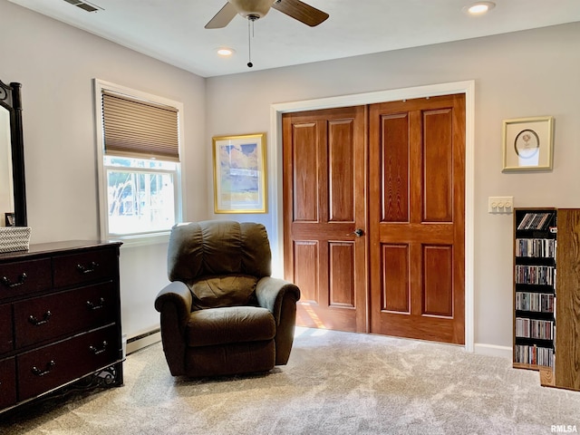 living area with a baseboard heating unit, baseboards, carpet flooring, recessed lighting, and a ceiling fan