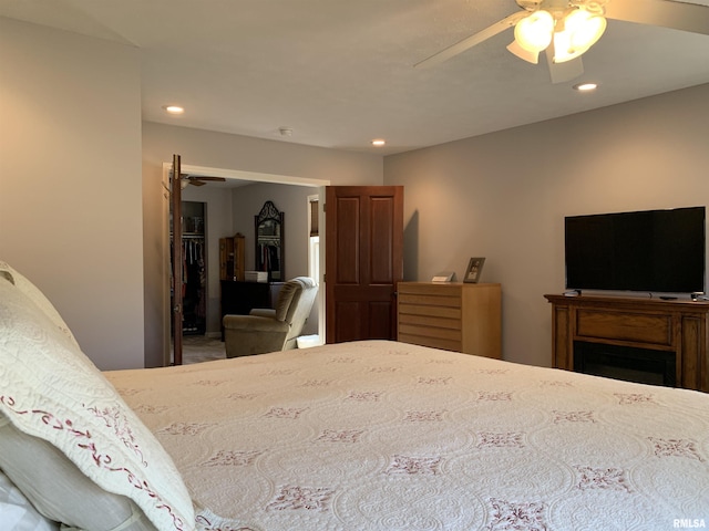 bedroom featuring recessed lighting, a walk in closet, a closet, and ceiling fan