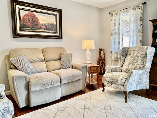 living area featuring baseboards and wood finished floors