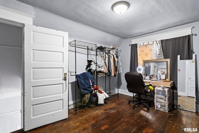 home office featuring baseboards, a textured ceiling, lofted ceiling, and hardwood / wood-style flooring