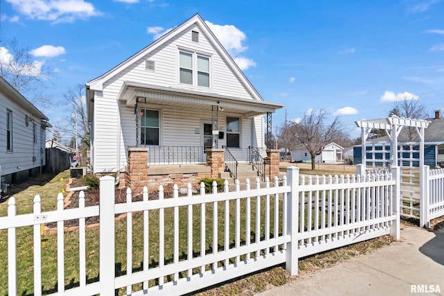 bungalow-style home featuring a fenced front yard, covered porch, concrete driveway, and a pergola