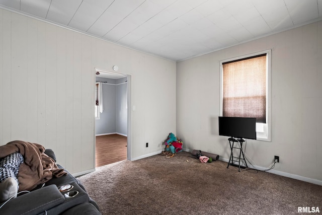 interior space featuring baseboards, carpet floors, and crown molding