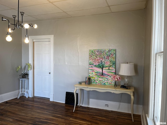 entrance foyer featuring wood finished floors, baseboards, and a paneled ceiling