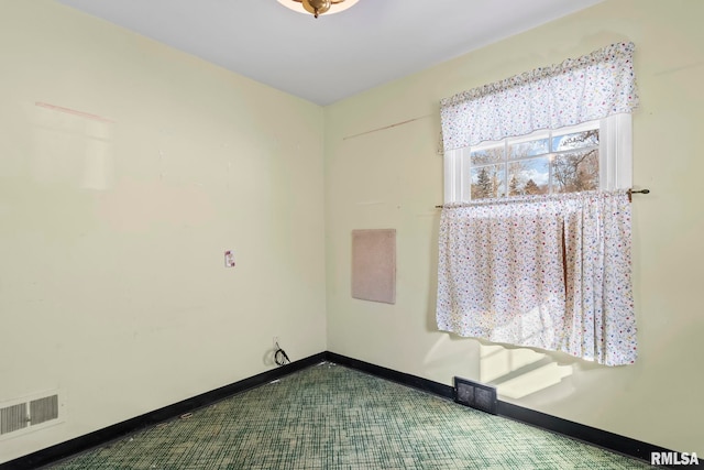 spare room featuring visible vents and baseboards