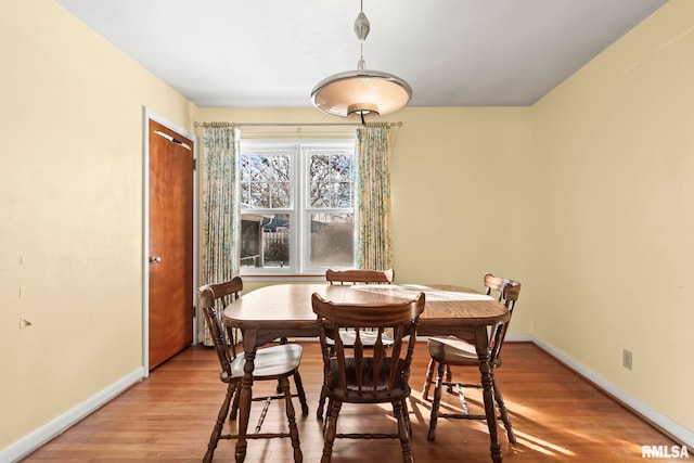 dining room featuring baseboards and wood finished floors