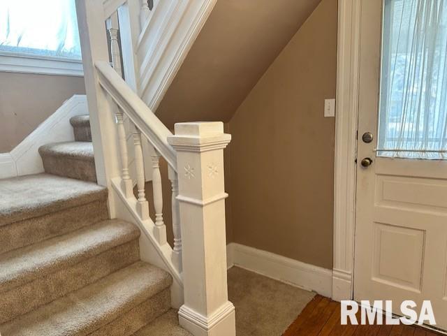 stairs featuring baseboards