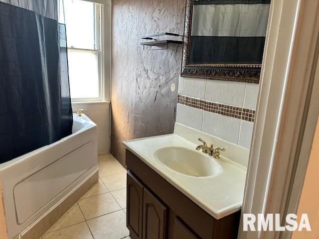 bathroom featuring tile patterned flooring, backsplash, vanity, and shower / bath combo