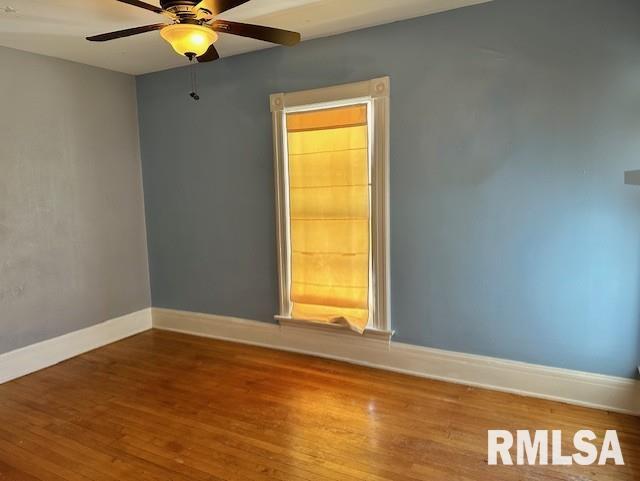 unfurnished room featuring ceiling fan, baseboards, and wood finished floors