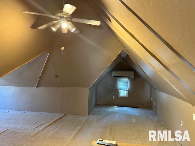 additional living space with vaulted ceiling, an AC wall unit, carpet flooring, and a ceiling fan