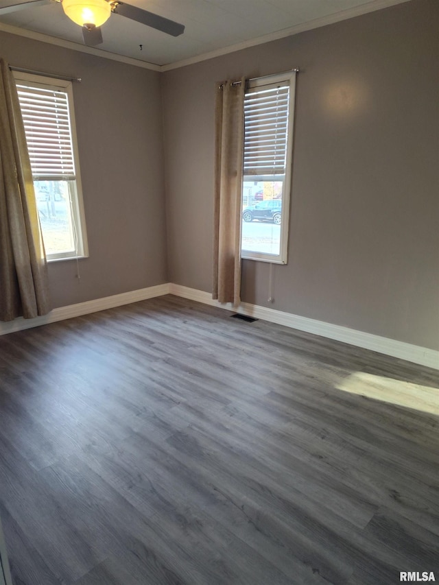 unfurnished room featuring ceiling fan, visible vents, dark wood-style flooring, and crown molding