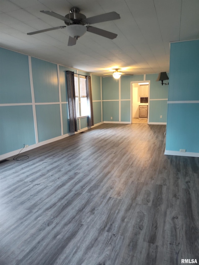 unfurnished room featuring wood finished floors and a ceiling fan