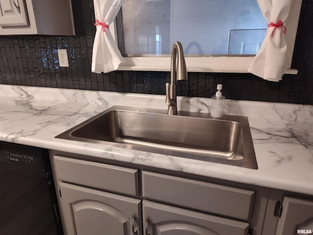 kitchen with a sink, decorative backsplash, dishwasher, and light countertops