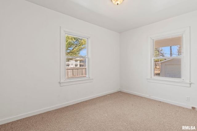 carpeted spare room with baseboards