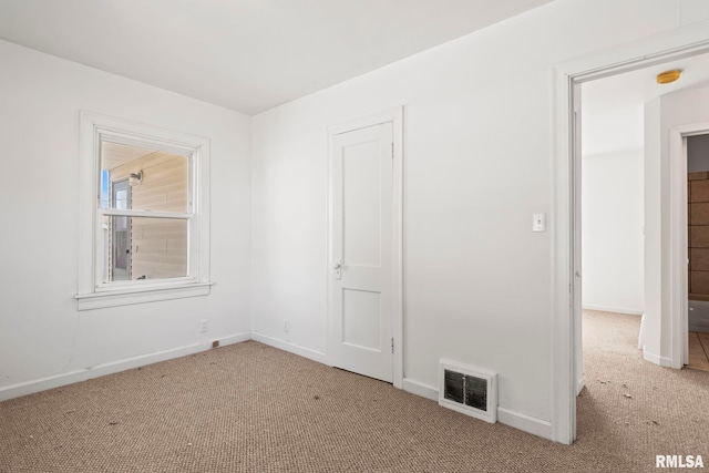 unfurnished bedroom featuring visible vents, baseboards, and carpet flooring