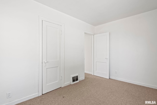 unfurnished bedroom with visible vents, baseboards, and carpet