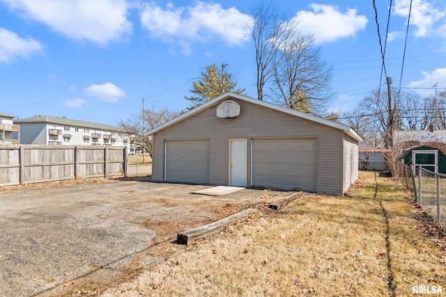 detached garage featuring fence