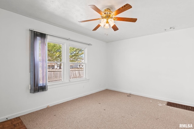 empty room featuring baseboards and ceiling fan