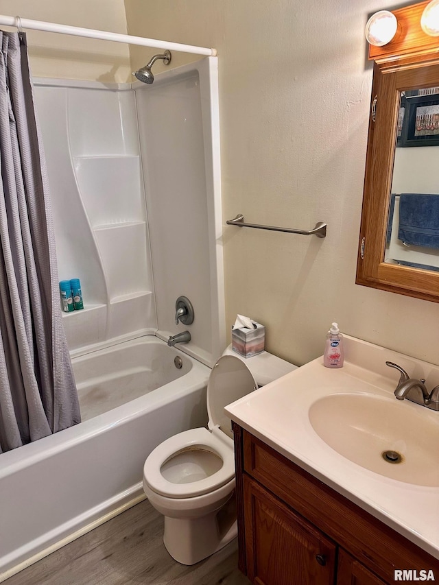 bathroom with toilet, shower / bath combo with shower curtain, vanity, and wood finished floors