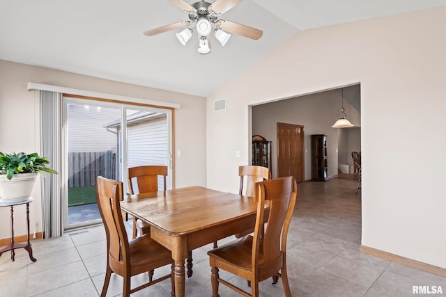 dining room featuring a ceiling fan, visible vents, baseboards, light tile patterned flooring, and vaulted ceiling