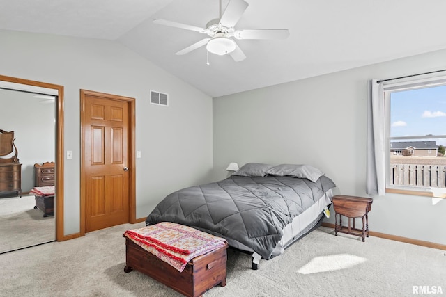 bedroom with visible vents, lofted ceiling, ceiling fan, a closet, and carpet flooring