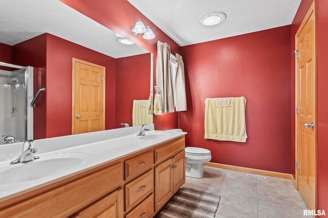 full bathroom with tile patterned flooring, a shower stall, baseboards, and a sink