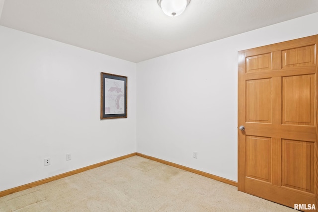 carpeted spare room with baseboards