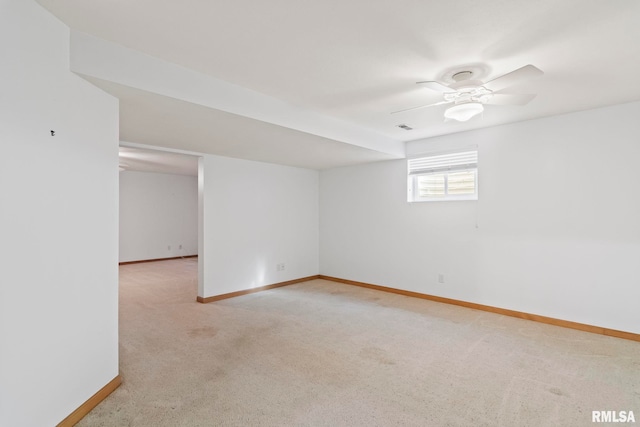 empty room featuring baseboards, light colored carpet, and ceiling fan