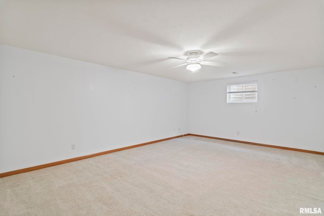 empty room featuring baseboards, ceiling fan, and carpet floors