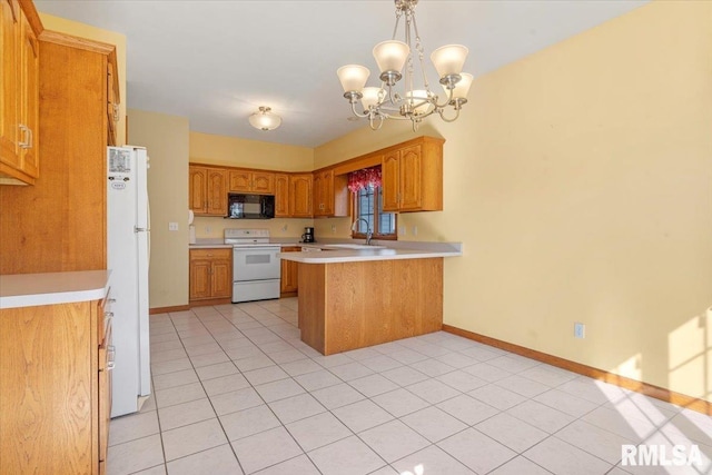 kitchen with white appliances, a peninsula, light countertops, baseboards, and a chandelier