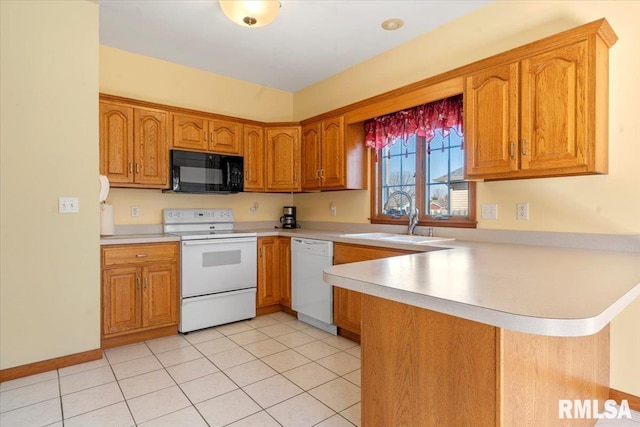 kitchen featuring light countertops, brown cabinets, a peninsula, white appliances, and a sink